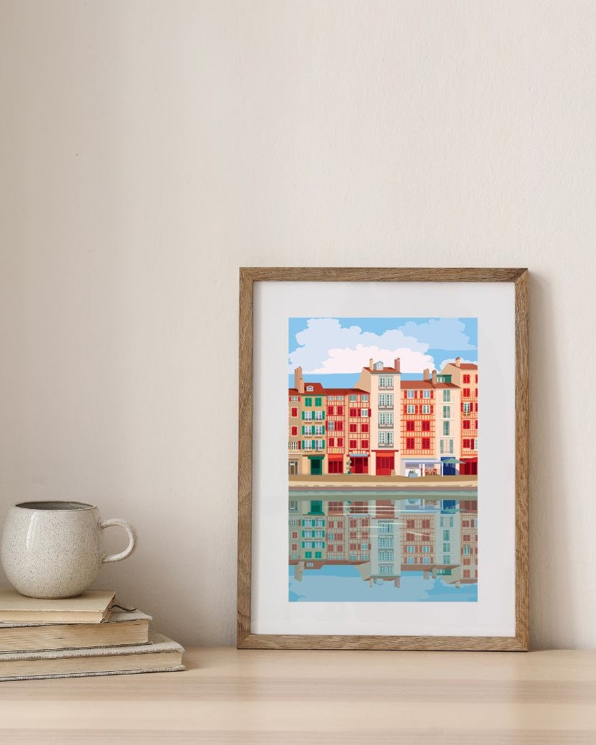 Affiche des façades de Bayonne dans un cadre en bois, sur un fond épuré.