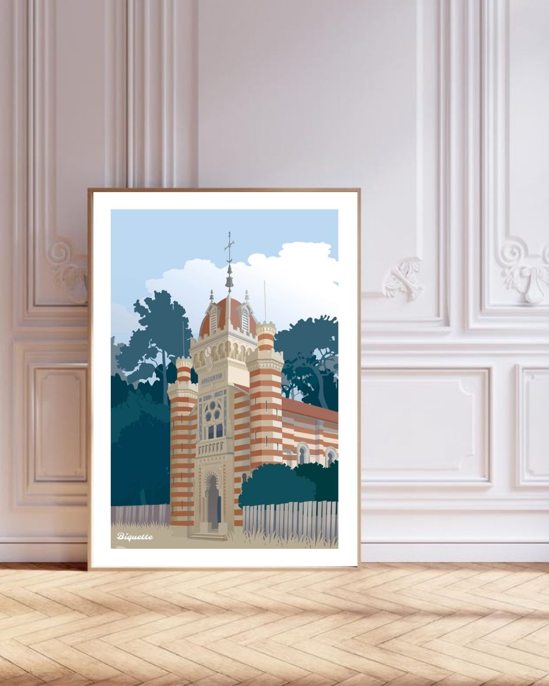 Grand cadre en bois adossé à un mur blanc orné de moulures classiques, mettant en valeur l'affiche graphique de la Chapelle Algérienne du Cap Ferret.